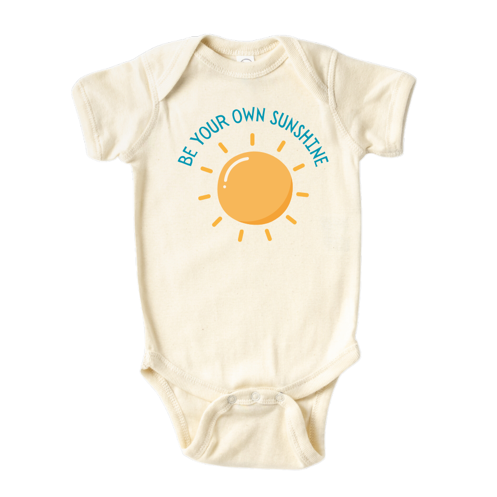 Natural Baby Onesie featuring an adorable printed graphic of a sun with the empowering text 'Be Your Own Sunshine.' Encourage positivity and self-confidence with this delightful tee.