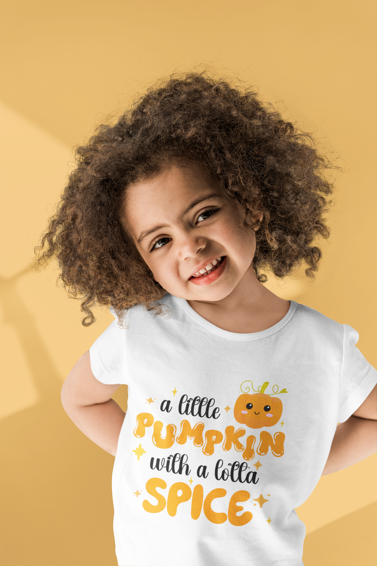 Cute fall pumpkin design shirt with text “a little pumpkin with a lotta spice” on baby bodysuit, kids’ t-shirt, sweatshirt, and adult tee.