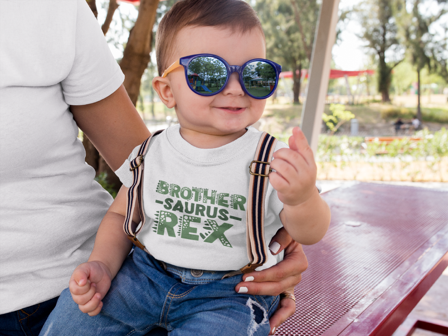 Brother-Saurus-Rex dinosaur graphic on baby bodysuit, toddler and kids t-shirt, unisex adult shirt, and children’s sweatshirt