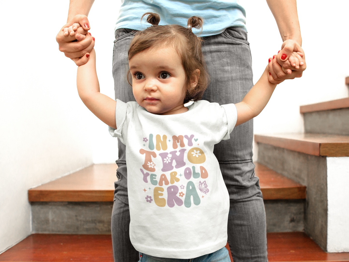Retro pastel “In My Two Year Old Era” shirt with flowers and butterflies, available as baby bodysuit or kids T-shirt.