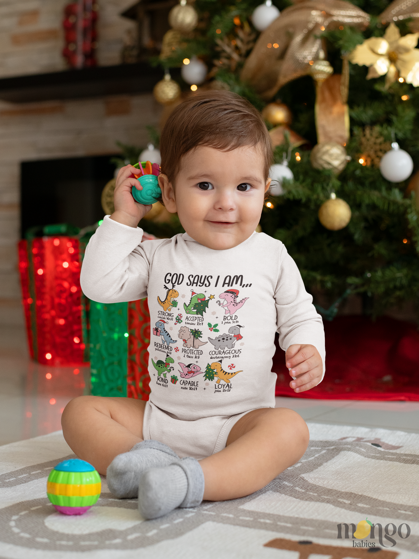 Christmas-themed “God Says I Am” shirt with cute dinosaur icons, available in baby, toddler, and kids sizes.