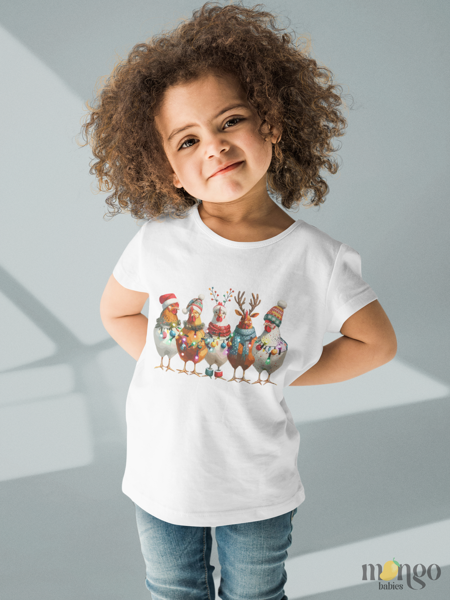Christmas-themed baby onesie and kids’ shirts featuring festive roosters and chickens in holiday designs.
