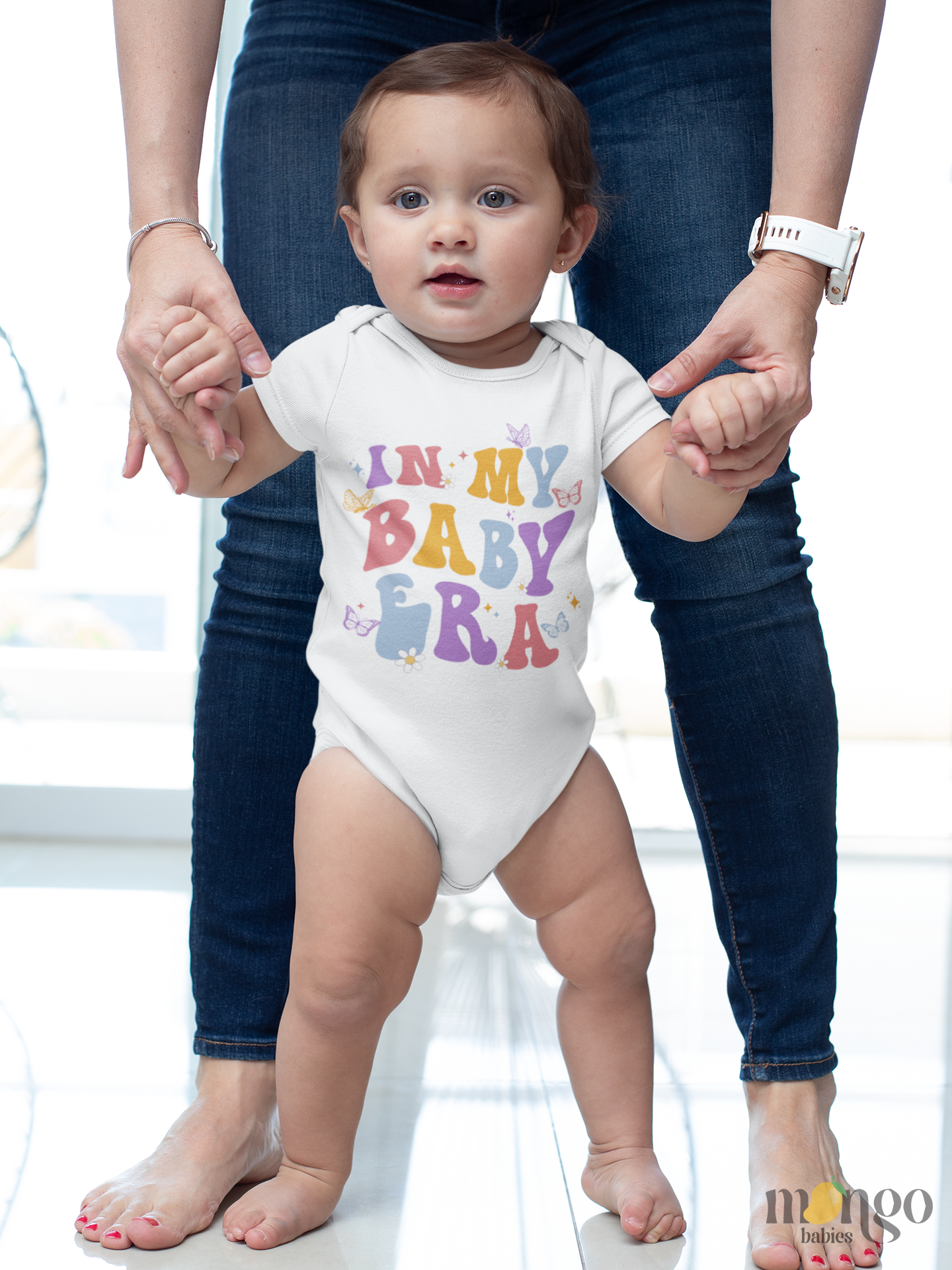 Retro-style baby bodysuit and kids’ T-shirt with butterfly graphic and “In My Baby Era” text, available in multiple sizes.