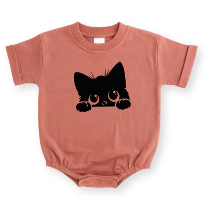 Minimalist black cat line drawing printed on a mauve baby romper with a cozy, modern aesthetic.