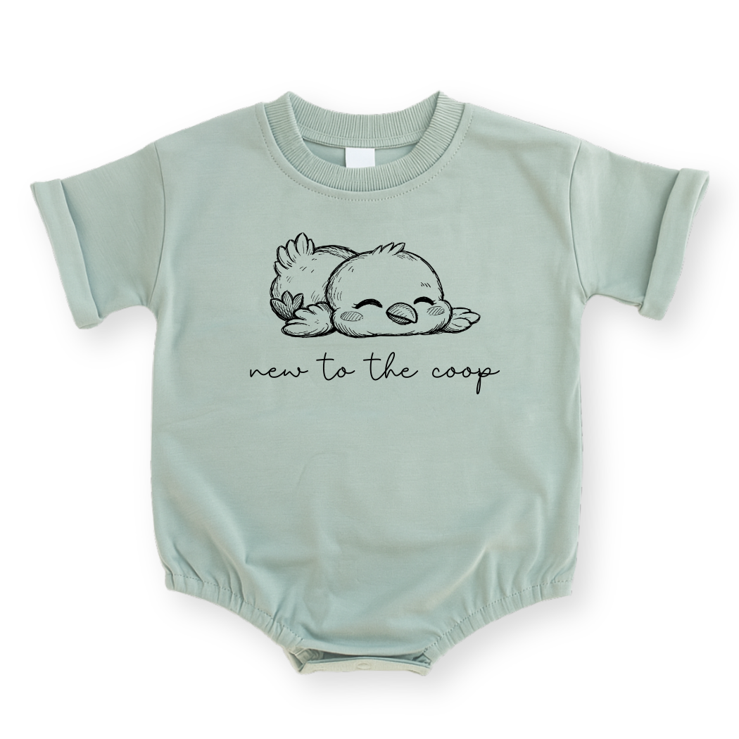 Minimalist "New to the Coop" baby romper in Sage green featuring a simple line drawing of a baby chicken and modern text.