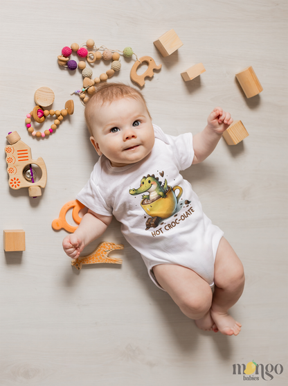 Cute crocodile sitting in a chocolate milk cup with text “HOT CROCO-LATE” printed on baby bodysuit, kids t-shirt, sweater, and adult unisex shirt.