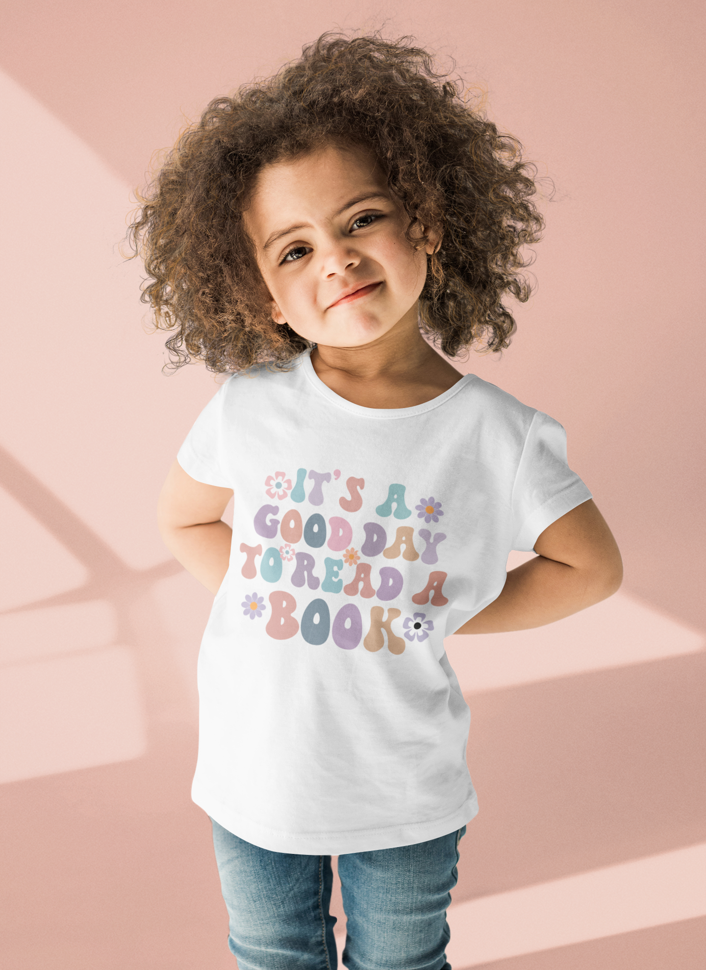 Retro text design “It’s a Good Day to Read a Book” printed on baby onesie and kids’ t-shirt.
