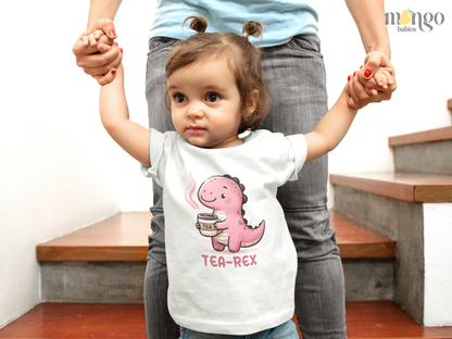 Cute pink T-Rex drinking tea with “TEA-REX” text on baby bodysuit, kids’ T-shirt, children’s sweater, and unisex adult shirt.