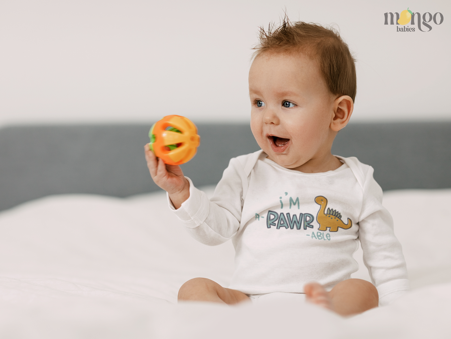 Cute dinosaur graphic shirt with text "I'm a-rawr-able" available in baby bodysuit, kids t-shirt, sweatshirt, and unisex adult shirt.
