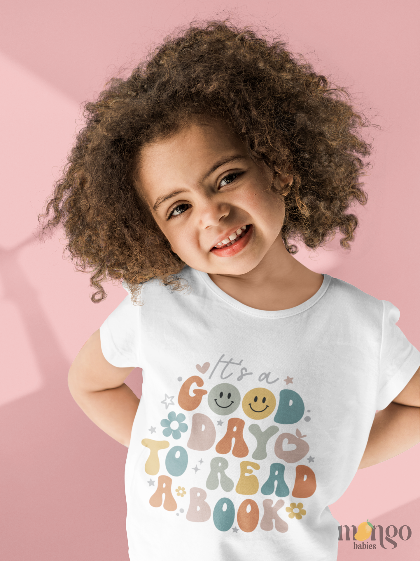 Retro-style “It’s a Good Day to Read a Book” shirt design on baby bodysuit and kids’ T-shirt, printed in warm vintage colors.
