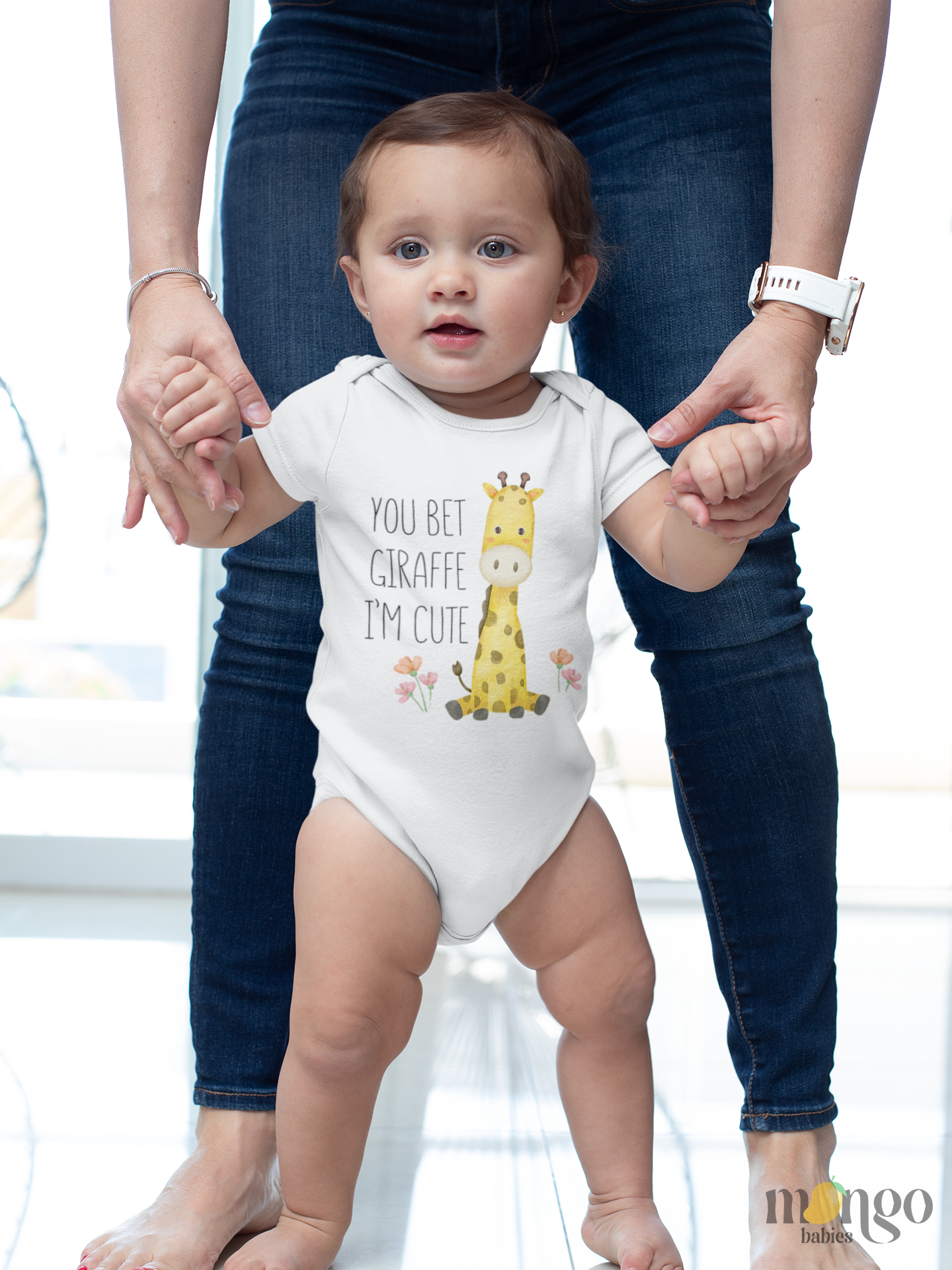 Cute giraffe graphic with text "You bet giraffe I'm cute" printed on baby bodysuit, kids’ t-shirt, sweatshirt, and adult shirt.