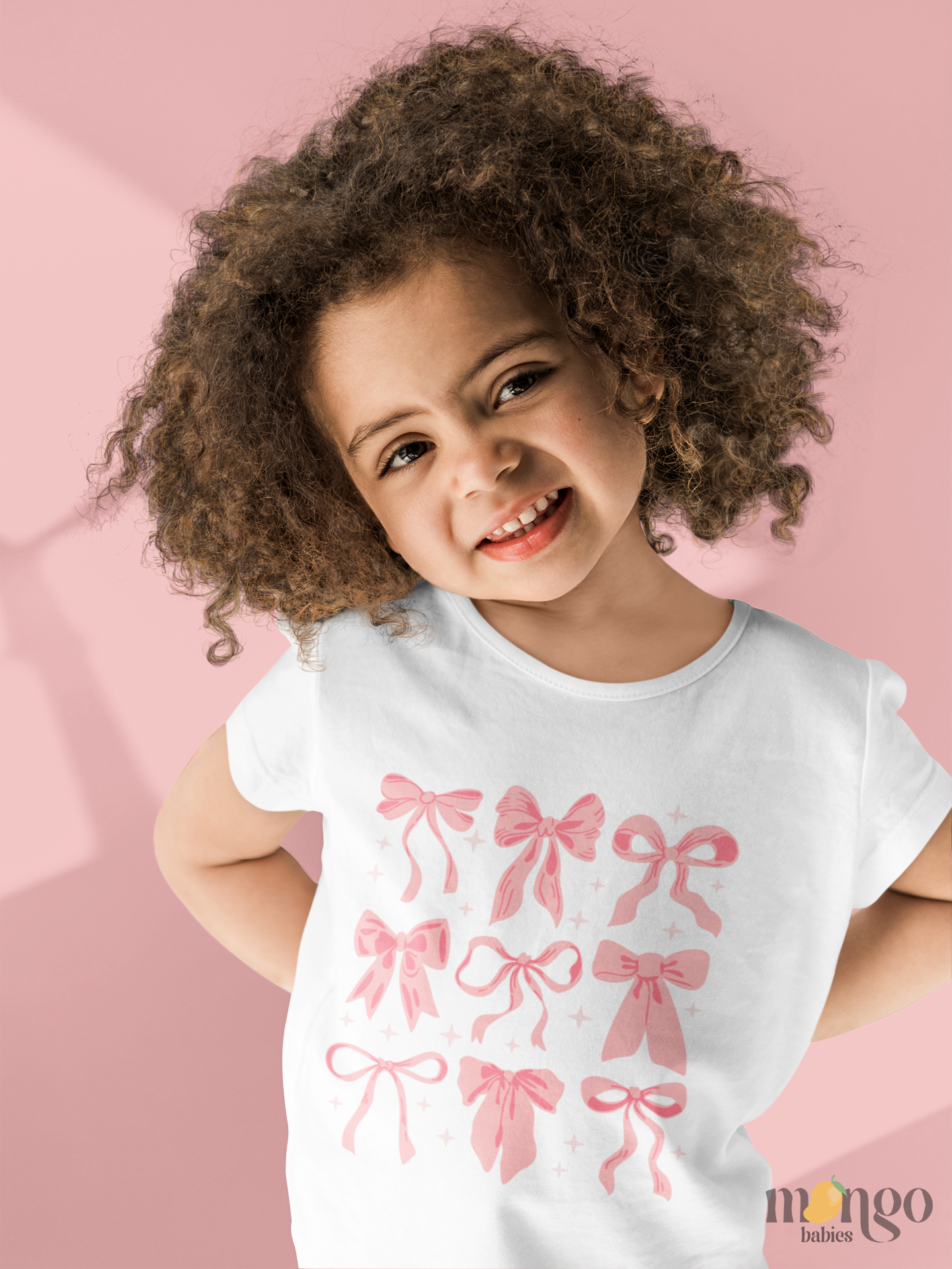 Sweet and simple pink bows design on soft baby bodysuits, kids' tees, sweaters, and unisex adult shirts. Cozy, cute, and perfect for matching moments.