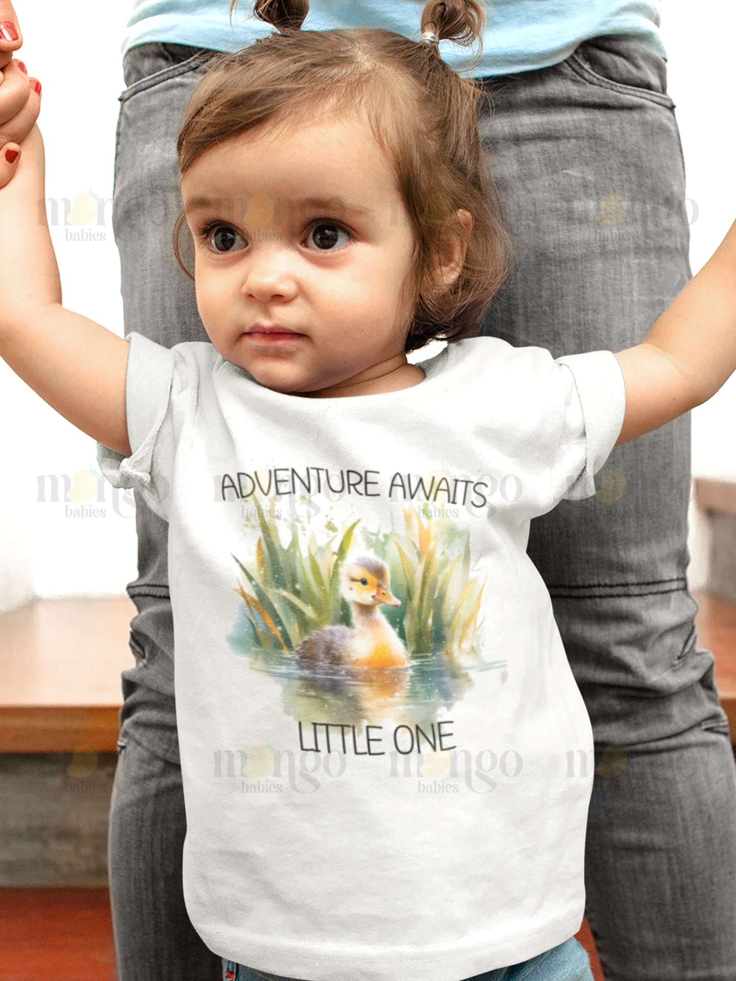 Cute duck graphic with the text “Adventure awaits little one” printed on baby bodysuit, toddler t-shirt, kids tee, children sweatshirt, and unisex adult shirt.