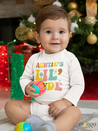 Baby bodysuit and kids’ t-shirt with retro text design “Auntie’s lil dude” in colorful lettering.