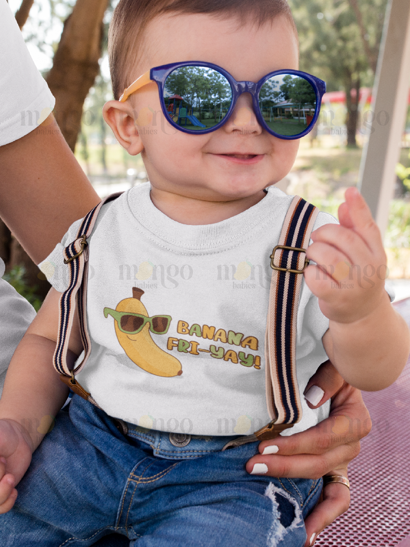 Cute banana wearing sunglasses with text “Banana Fri-yay!” printed on baby onesie, kids t-shirt, children’s sweatshirt, and adult unisex shirt.