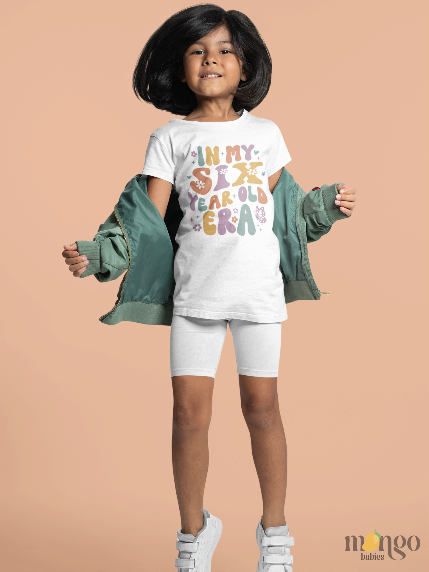 Retro pastel kids’ T-shirt with “In My Six Year Old Era” text, flowers, and butterflies. Soft cotton, perfect birthday shirt for six-year-olds.
