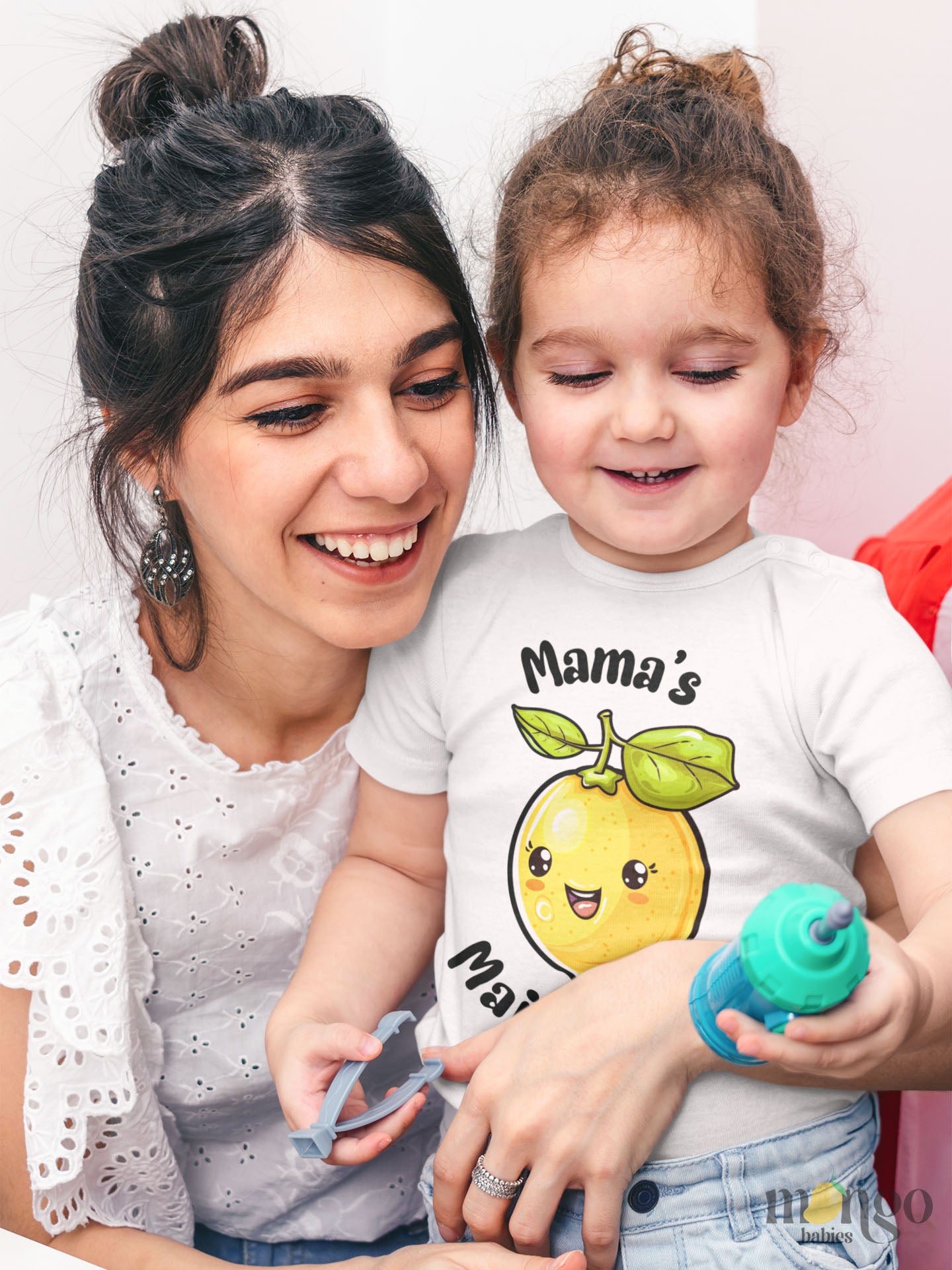 Cute baby onesie and kids’ t-shirt with lemon graphic and text “Mama’s Main Squeeze,” soft cotton, unisex design for babies and toddlers.