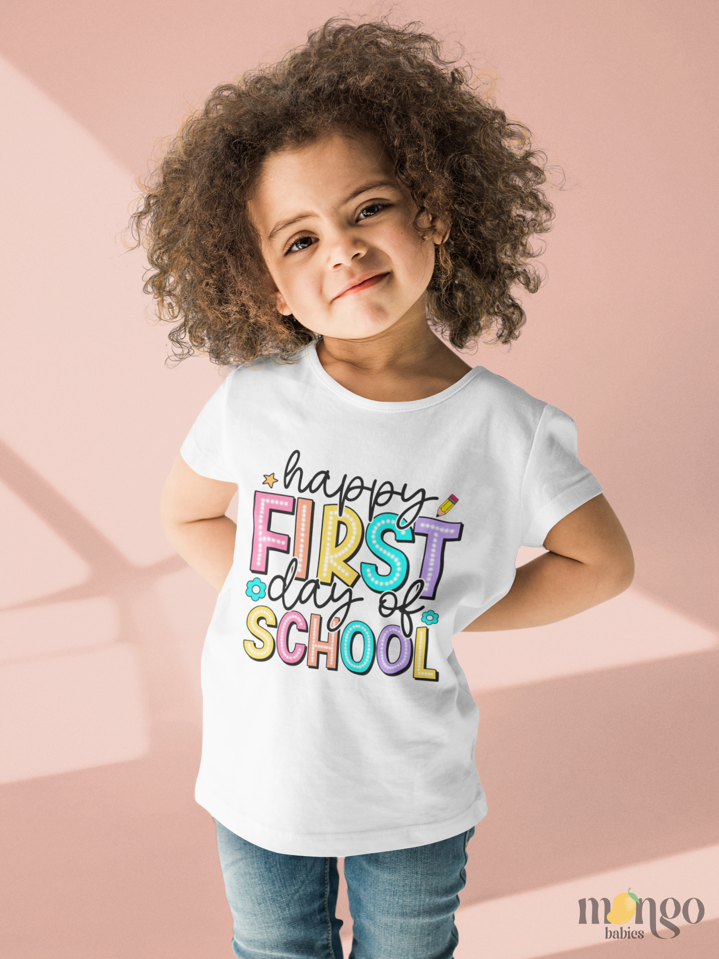 Colorful “Happy First Day of School” text printed on baby bodysuit, kids’ t-shirt, children’s sweater, and unisex adult shirt.